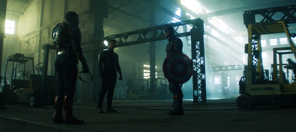Sam, Bucky, and John Walker confront each other in a warehouse.